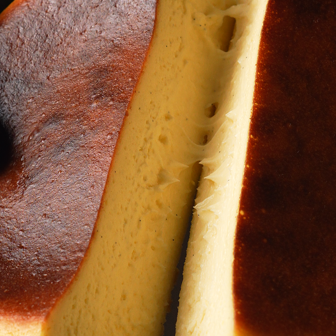 Two slices of cheesecake with a dark background