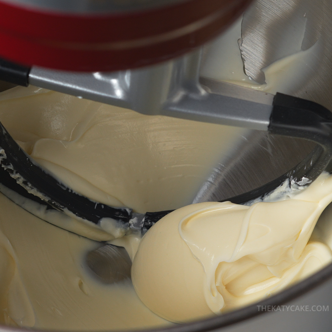 Close-up of a stand mixer with cream cheese in a bowl